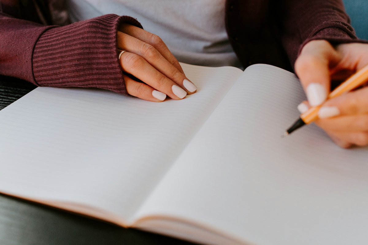 woman filling in journal