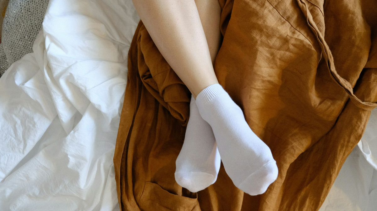 woman wearing socks in bed