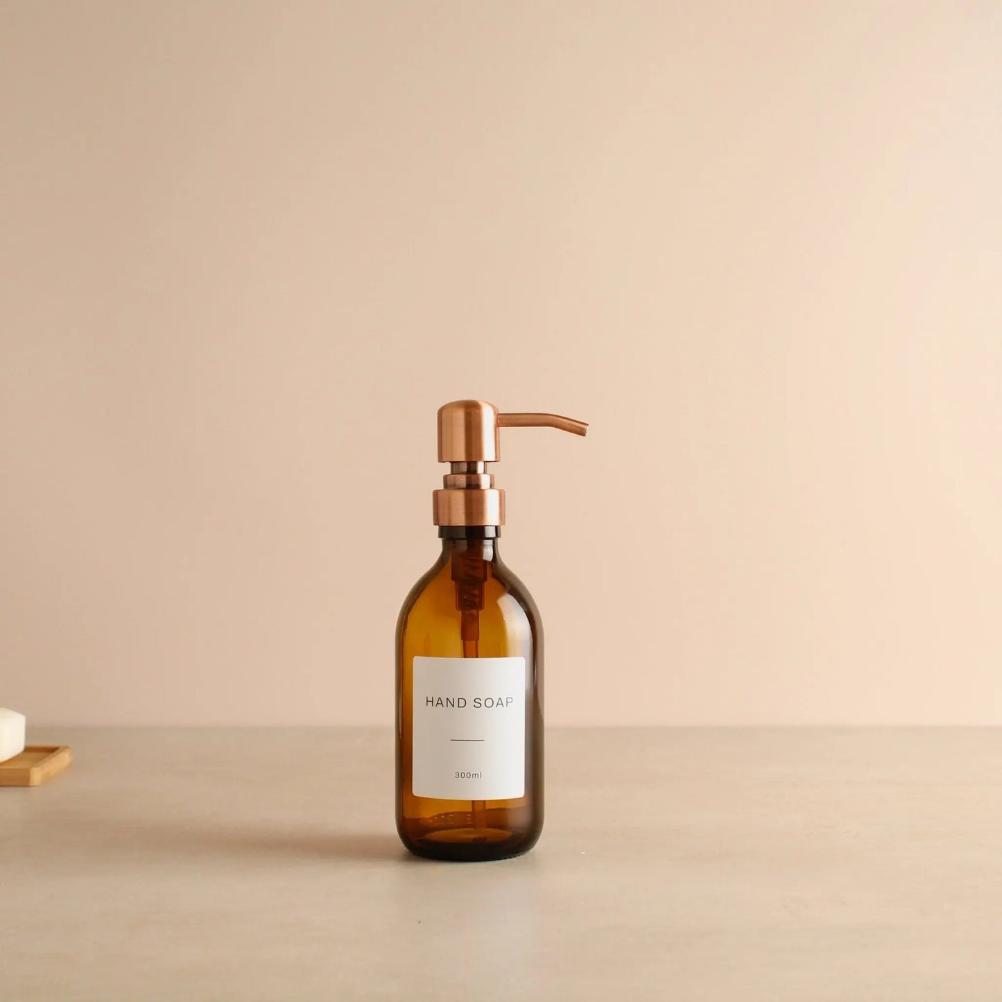 Labelled Amber Glass Dispenser Bottle With Rose Gold Pump Namie Home