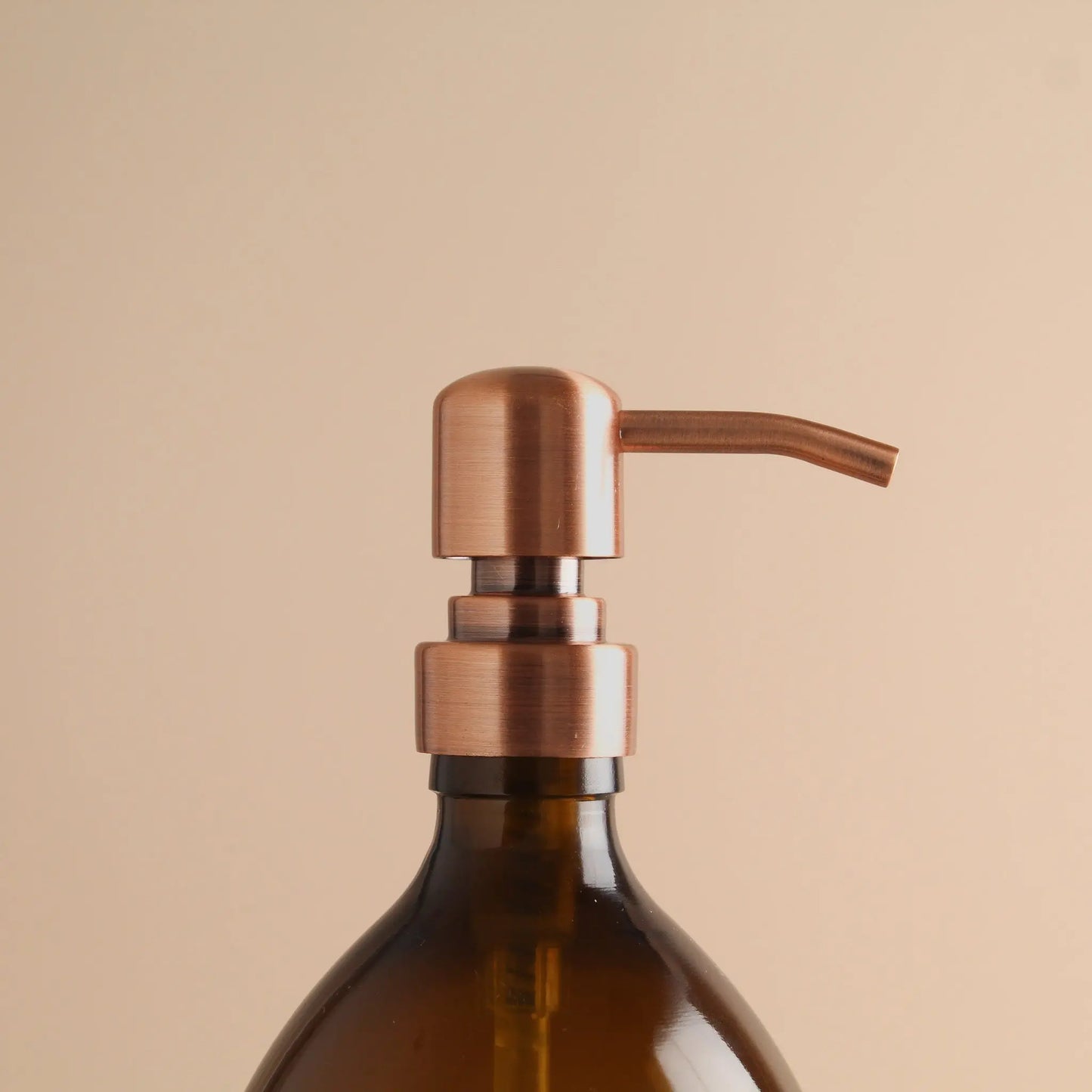 Labelled Amber Glass Dispenser Bottle With Rose Gold Pump Namie Home