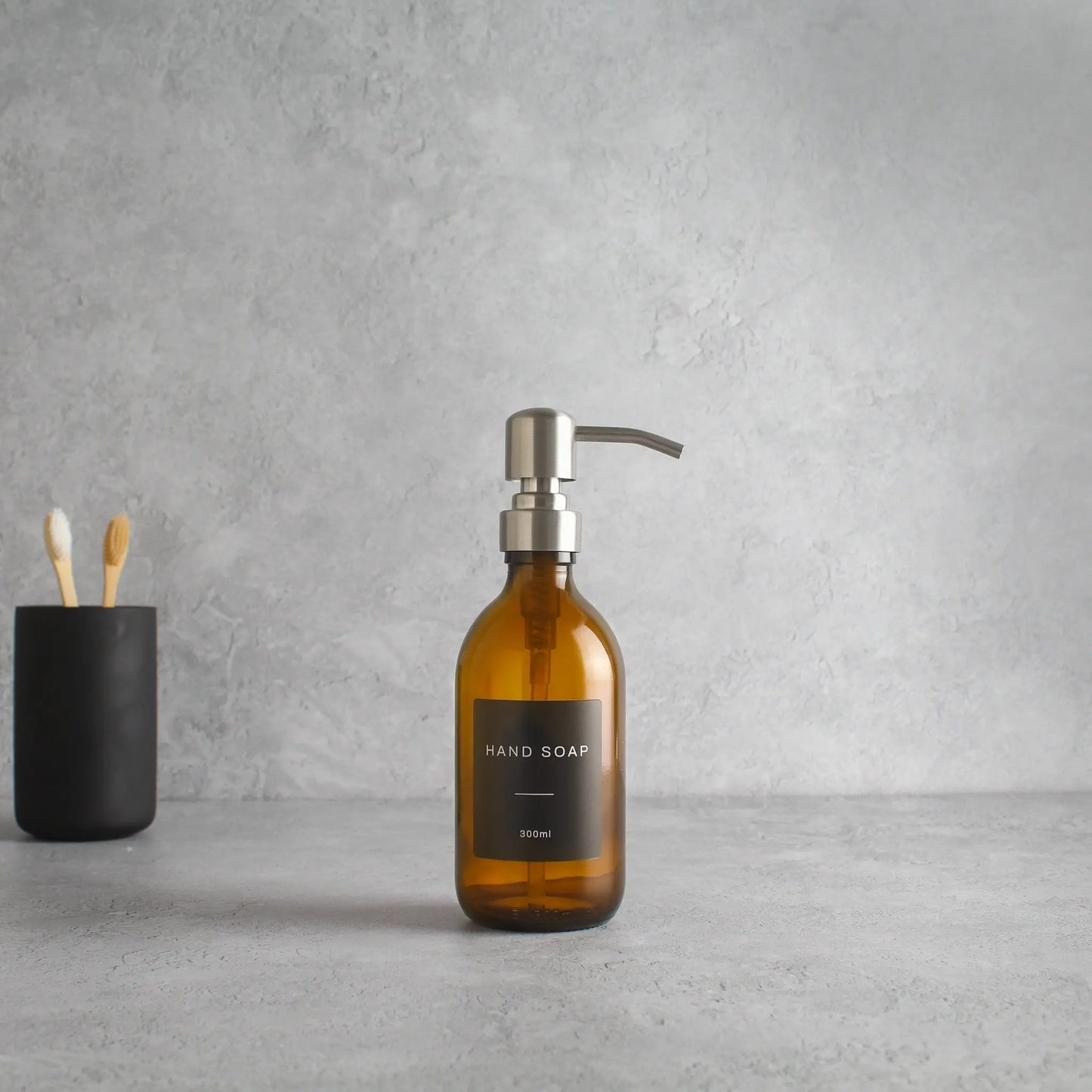 Labelled Amber Glass Dispenser Bottle With Silver Pump Namie Home