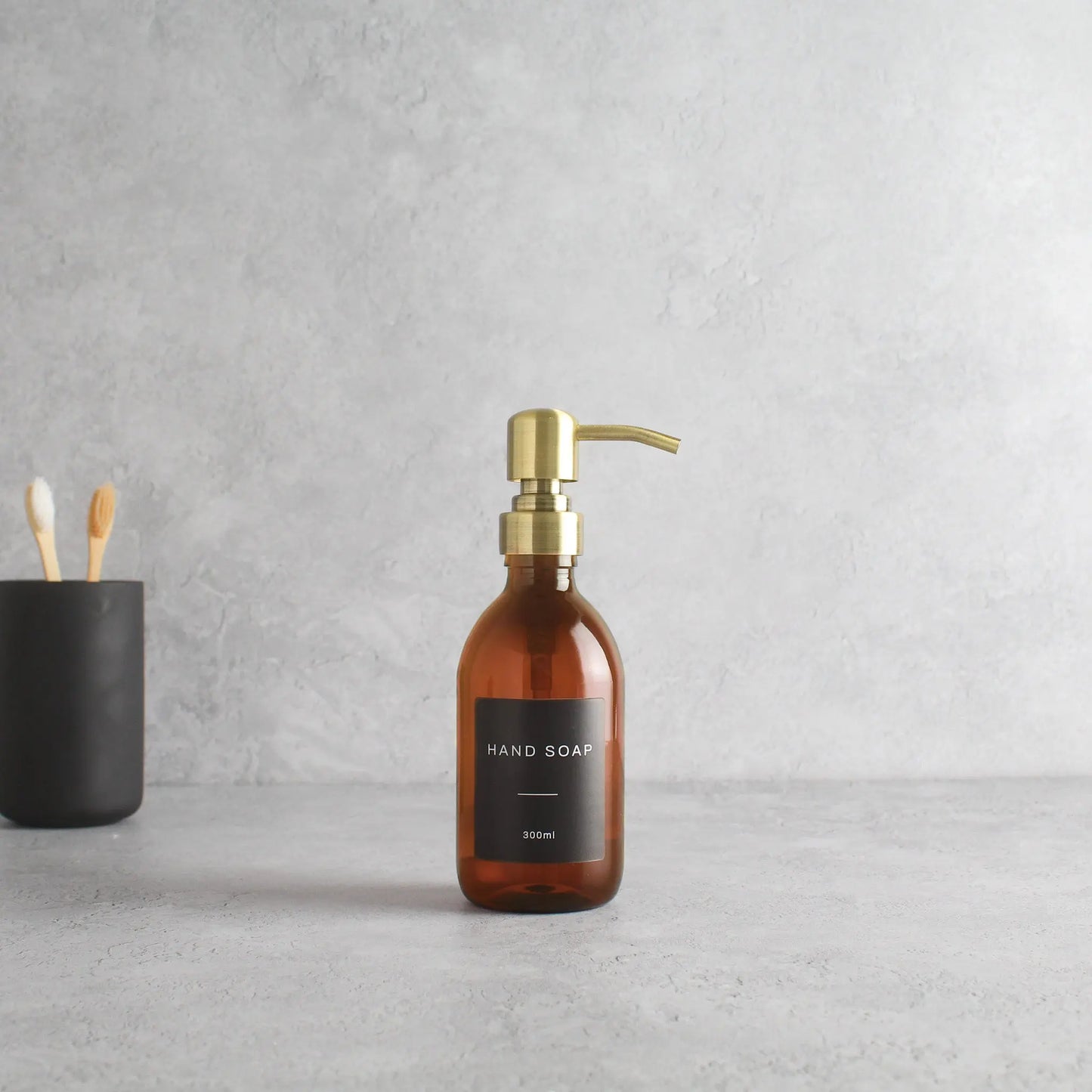 Labelled Amber Plastic Dispenser Bottle With Gold Pump Namie Home