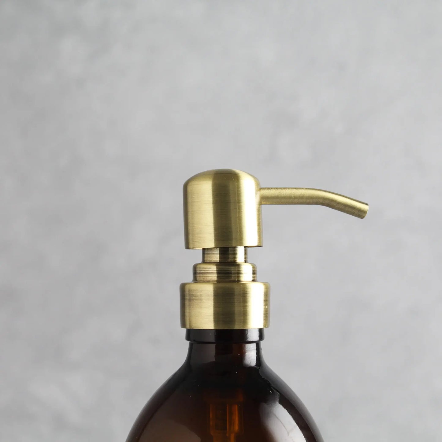 Labelled Amber Plastic Dispenser Bottle With Gold Pump Namie Home