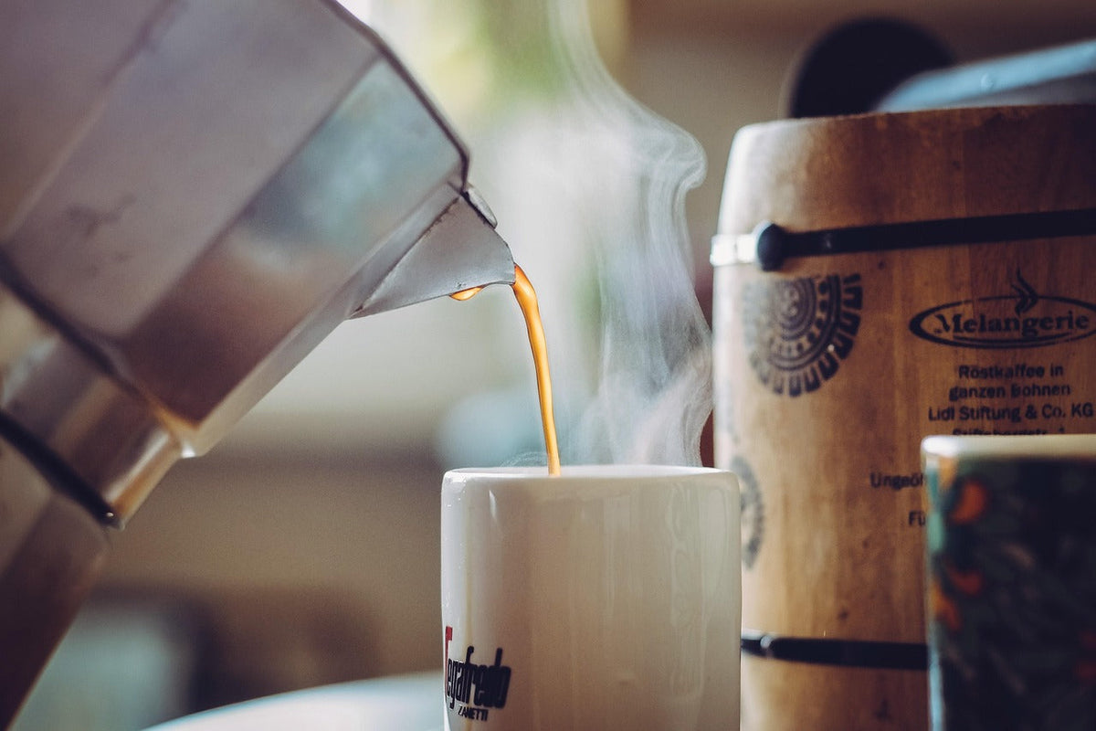 coffee being poured into cup