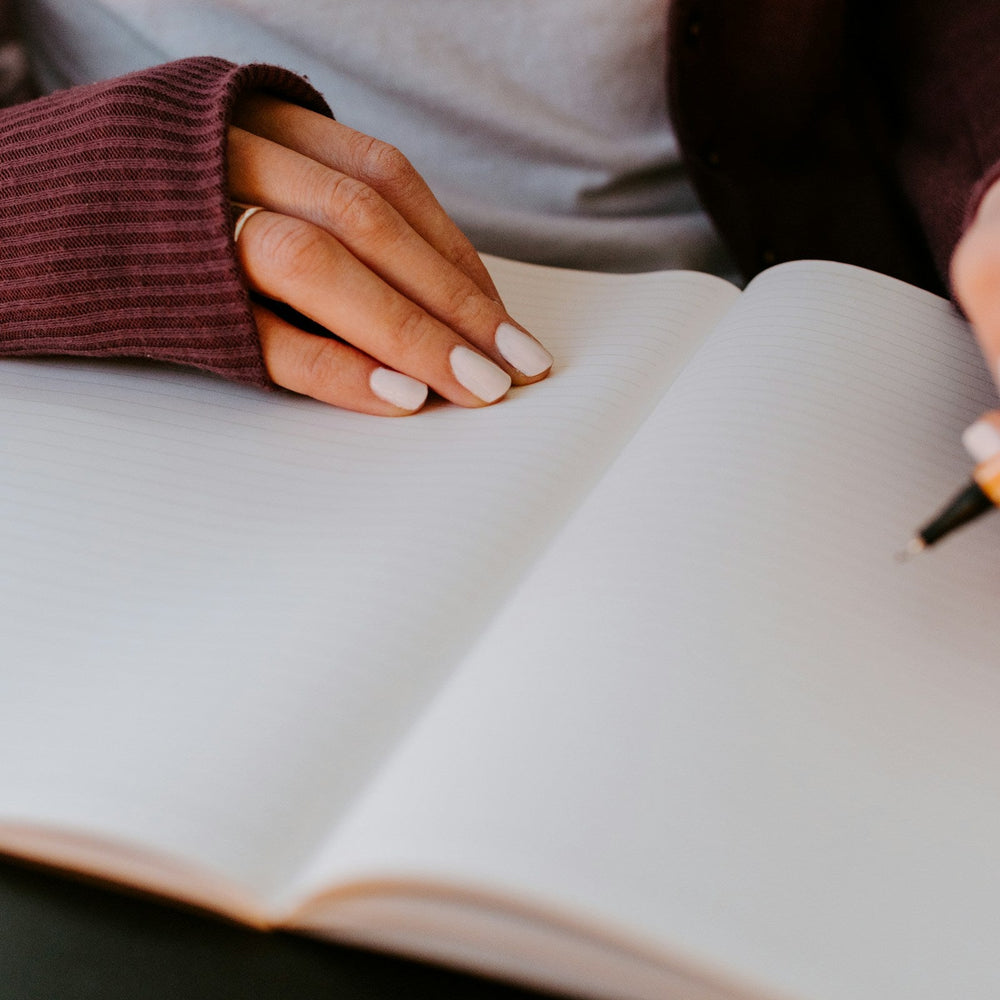 woman filling in journal