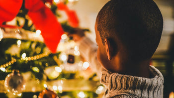 Kids and Teens Christmas - boy, back of head, decorating a Christmas tree