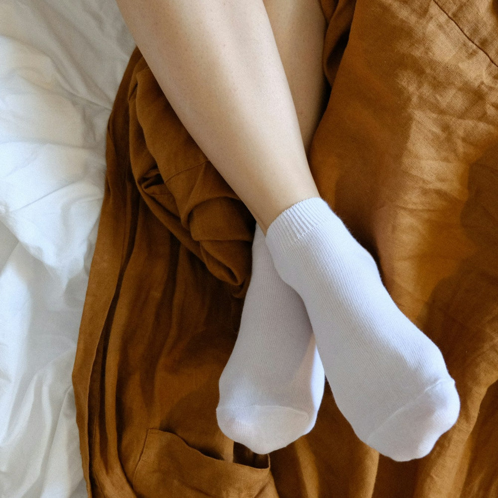 woman wearing socks in bed 