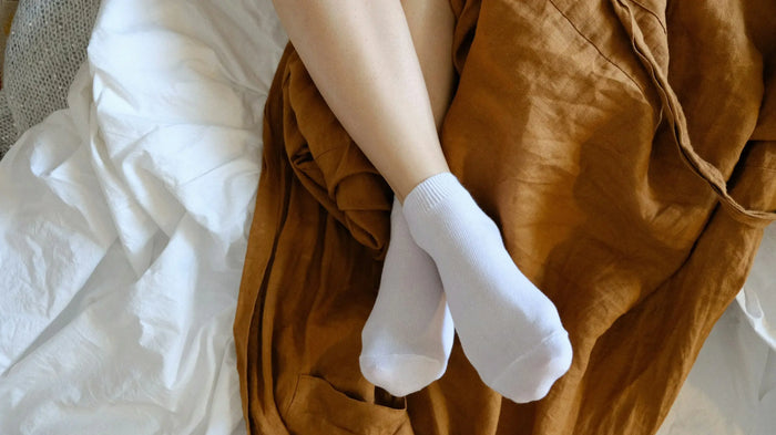 woman wearing socks in bed 