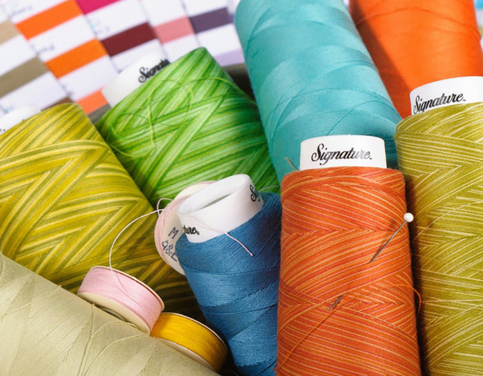 multi-coloured threads on spools