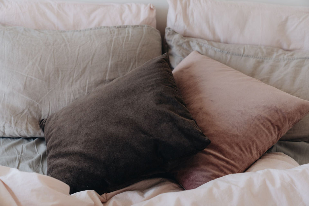 Two uncovered white pillows stacked on each other