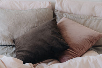 Two uncovered white pillows stacked on each other