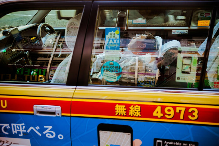 man sleeping in Japanese taxi 