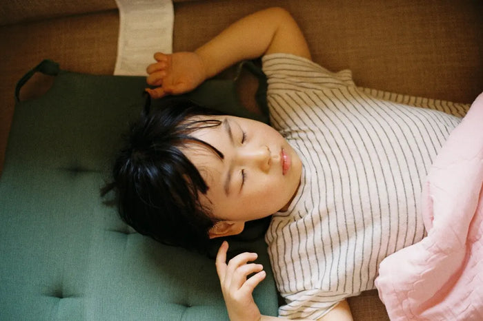 birds eye view of child sleeping on back