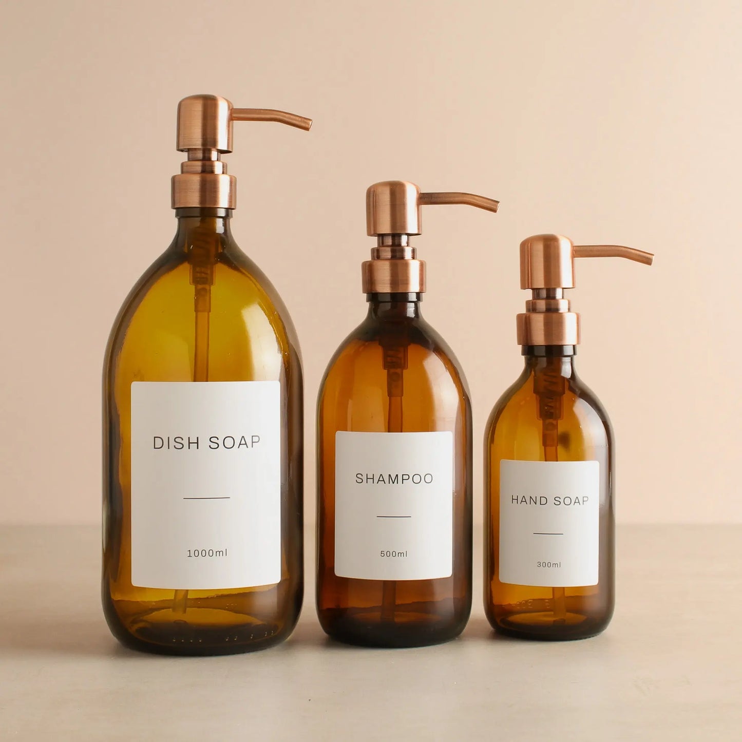 Labelled Amber Glass Dispenser Bottle With Rose Gold Pump Namie Home