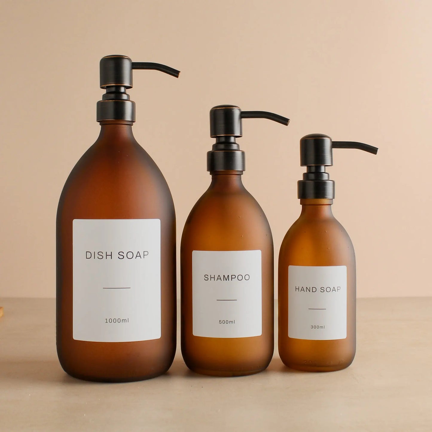 Labelled Frosted Amber Glass Dispenser Bottle With Black/Copper Pump Namie Home