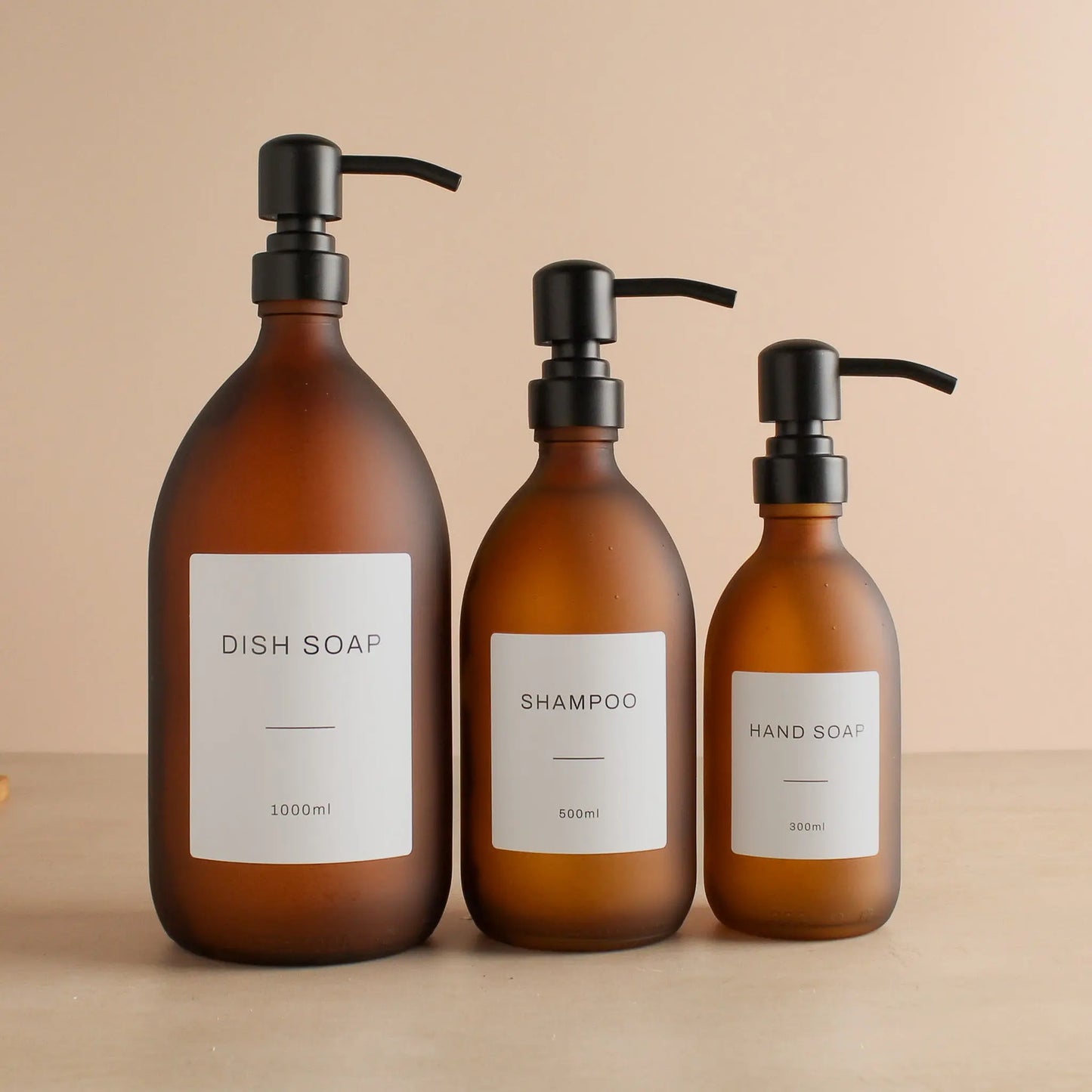 Labelled Frosted Amber Glass Dispenser Bottle With Matte Black Pump Namie Home