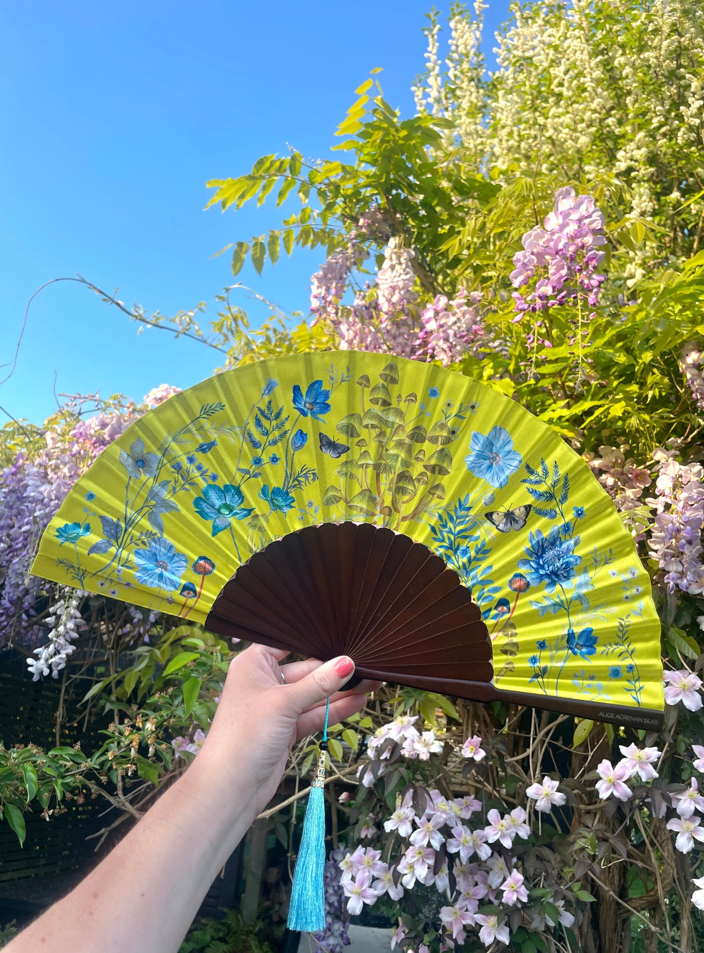 Bright yellow  'Luciferin' silk folding hand fan with flowers and mushroom painted artwork Alice Acreman Silks