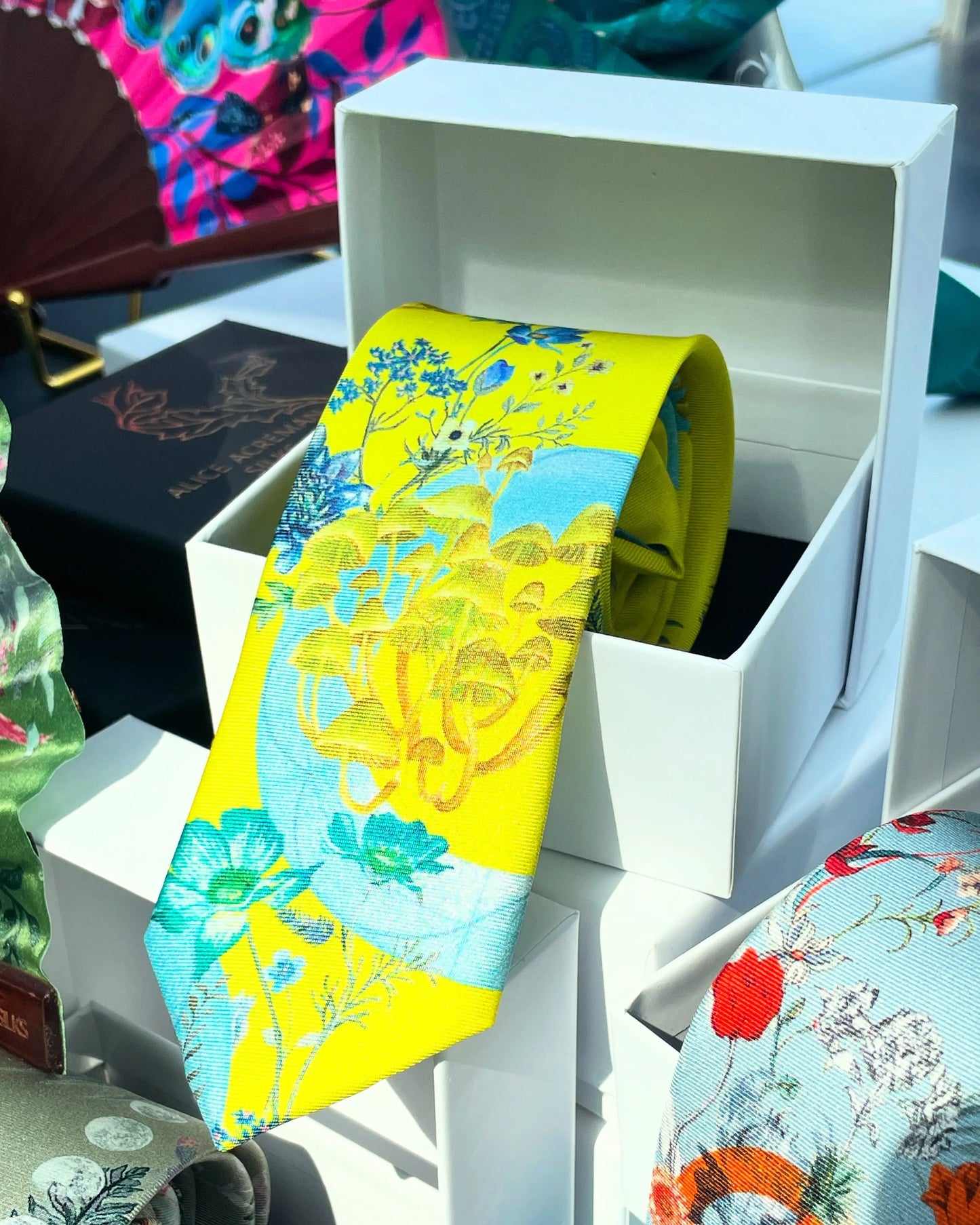 Vibrant yellow and pale blue ‘Luciferin’ floral silk tie Alice Acreman Silks