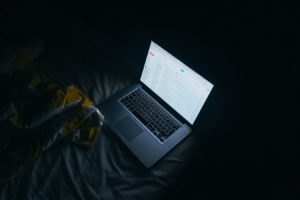Laptop on, in a dark room