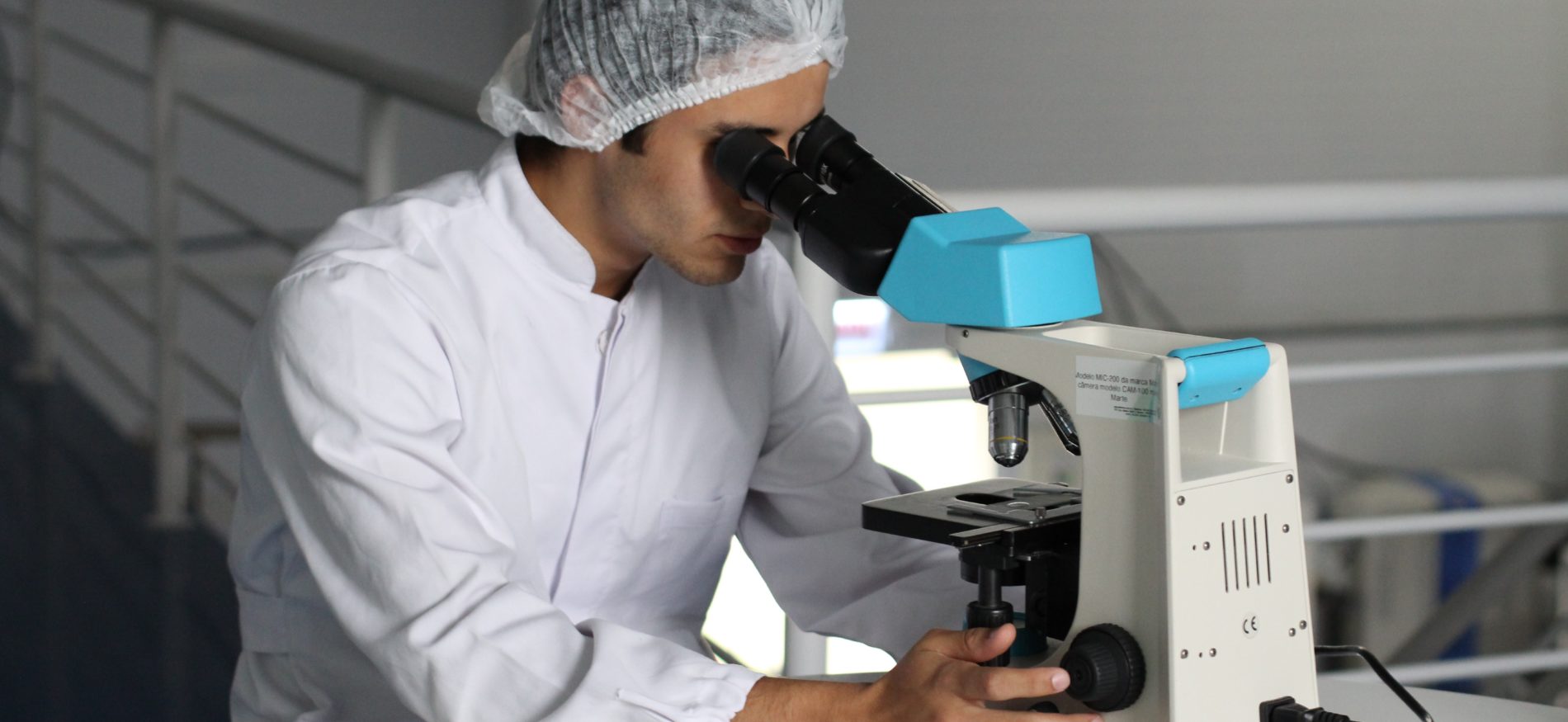 Scientist looking into microscope