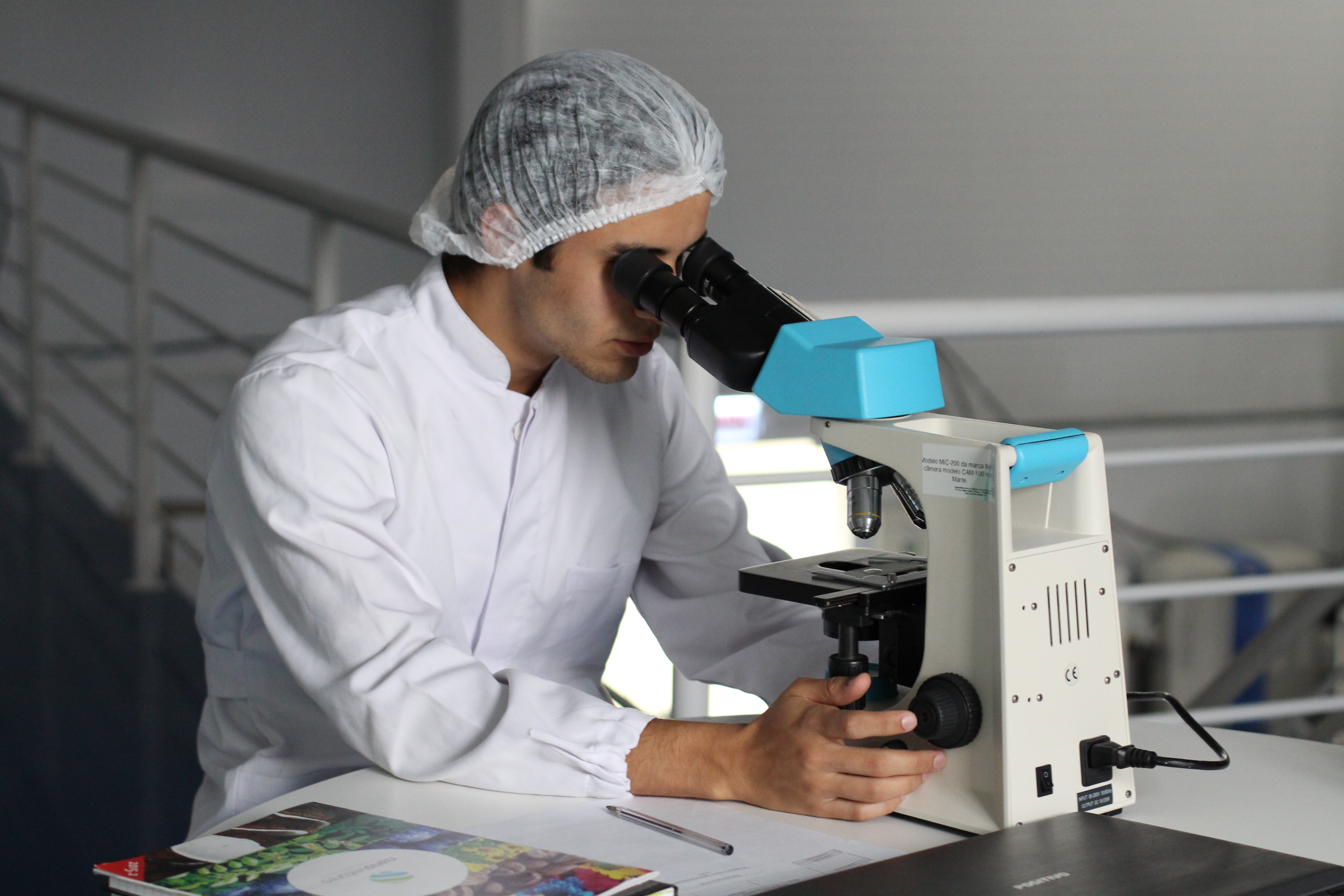 Scientist looking into microscope